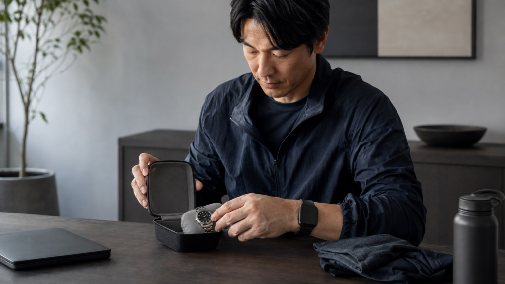 運動前にクラシックな腕時計を柔らかいケースへ収納しスマートウォッチへ着け替える日本人
